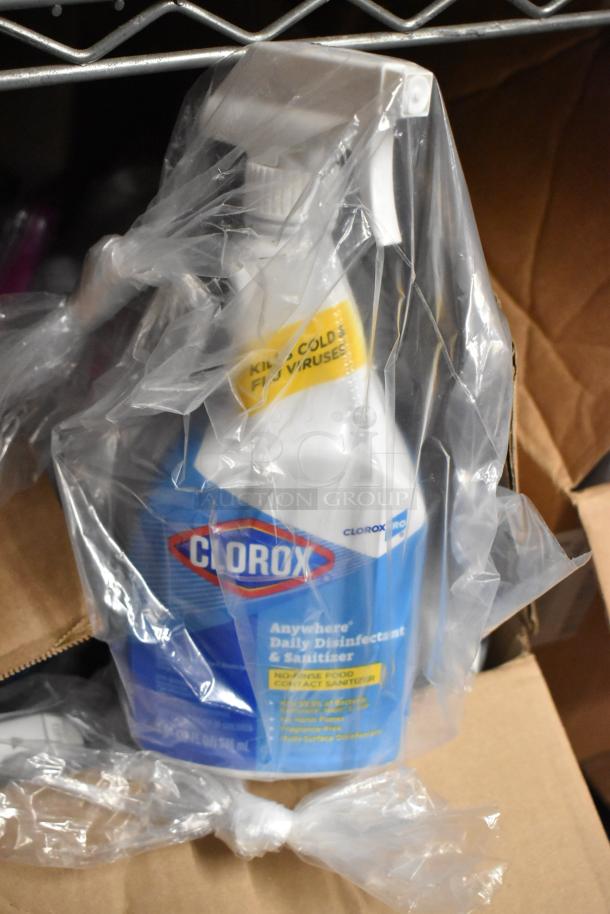 Clorox Anywhere Daily Disinfectant and Sanitizer Spray bottle wrapped in plastic, part of a 53-bottle auction bundle.