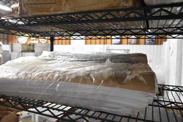 Seven various boxes on shelves, including Provon Foaming Handwash and Diversey Heavy Duty Grease Cleaner, wrapped in plastic.