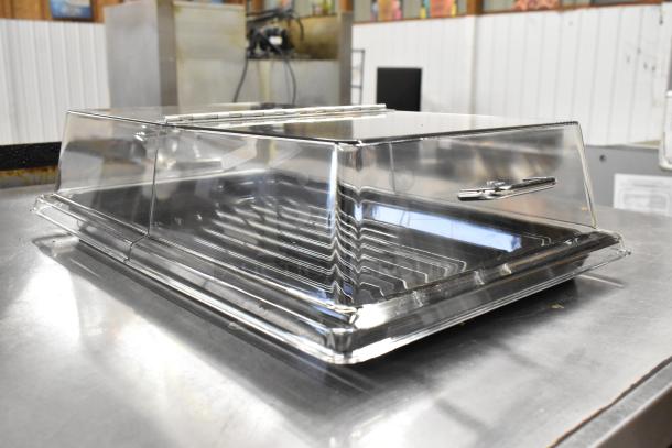72 new Cambro rectangular display covers with black trays, scratch and dent condition. 12x20", clear/chrome.