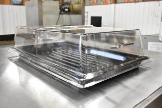 72 new Cambro rectangular display covers with black trays, scratch and dent condition. 12x20", clear/chrome.