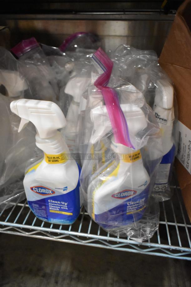 58 bottles of Clorox Clean-Up Disinfectant Cleaner with Bleach, sealed, on a shelf; features kill 99.9% of germs.