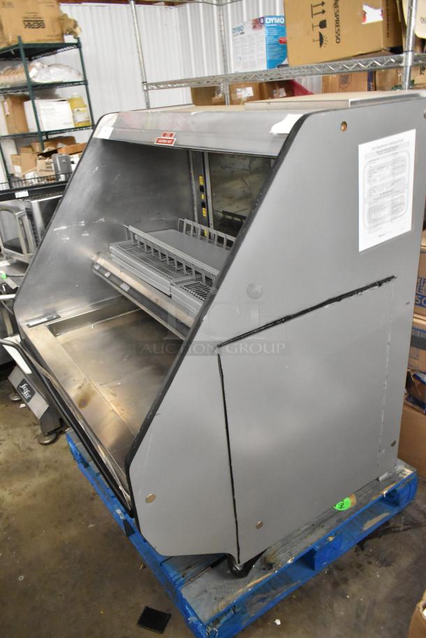 Metal commercial horizontal Grab N Go merchandiser, gray, with shelving; slight wear, contains cleaning guide label.