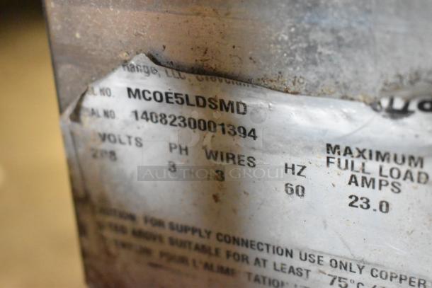 Garland MCOE5LDSMD stainless steel half-size convection oven, 208V, 3-phase, with solid door, metal racks, on casters.