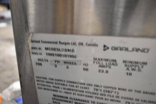 2019 Garland MCOE5LDSMD stainless steel commercial electric convection oven, 208V, 3 phase, solid door, metal racks.