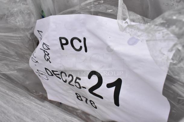 Alt Text: "Tag on wrapped packaging, labeled 'PCI DEC25-21' with additional handwritten notes."
