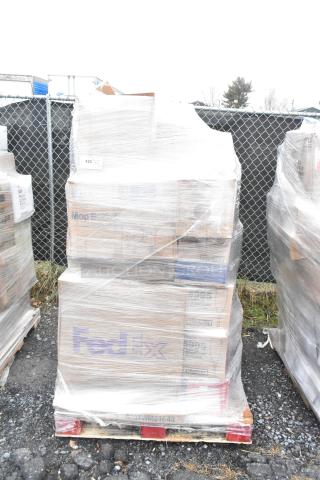 Pallet of 23 scratch and dent items, including sealed boxes labeled "FedEx" and "Mop Bucket," wrapped in plastic.