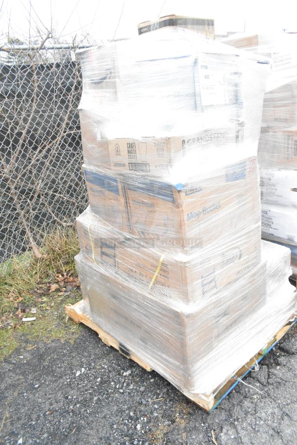 Pallet of 22 brand new scratch and dent items wrapped in plastic, including glasses, work table legs, and casters.