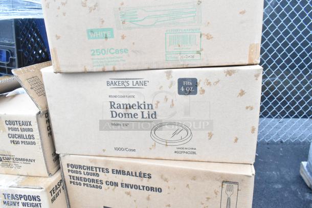 Stacked shipping boxes labeled "Baker's Lane Ramekin Dome Lid" fitting 4 oz, 1000 per case. Visible marks and labels.