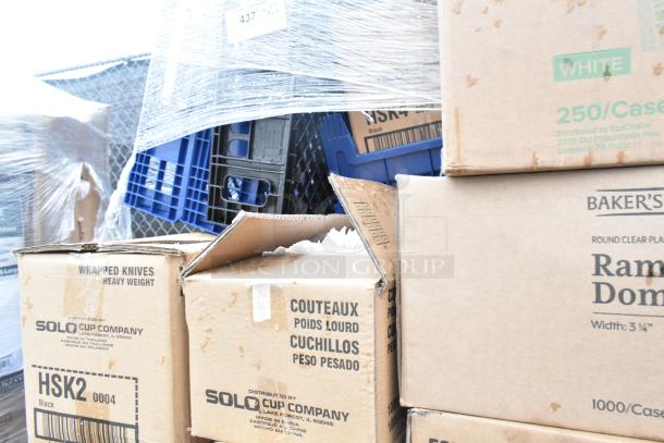 Boxes of bakery bread trays, teaspoons, ramekin cups, and other items, some marked "scratch and dent," on pallet.