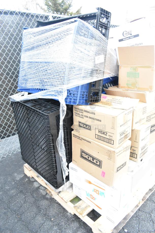 Stack of new scratch and dent items including bakery trays, teaspoons, and ramekins on a pallet. Various boxes visible.