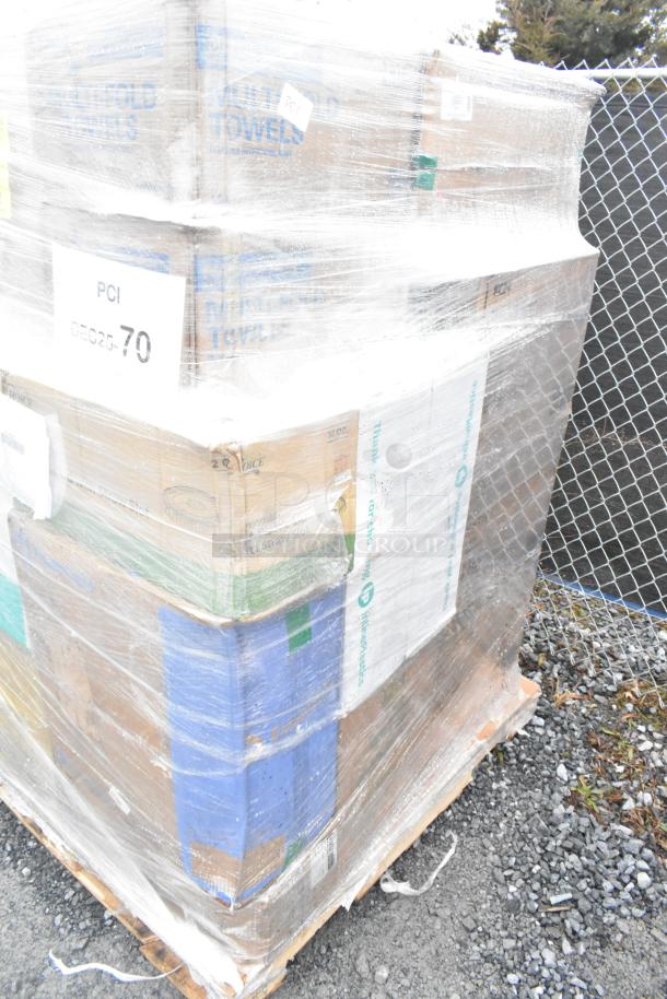 Shrink-wrapped pallet with assorted boxes of new scratch and dent items like cold cups, hot cups, napkins, and towels. Labels indicate brands and item types.