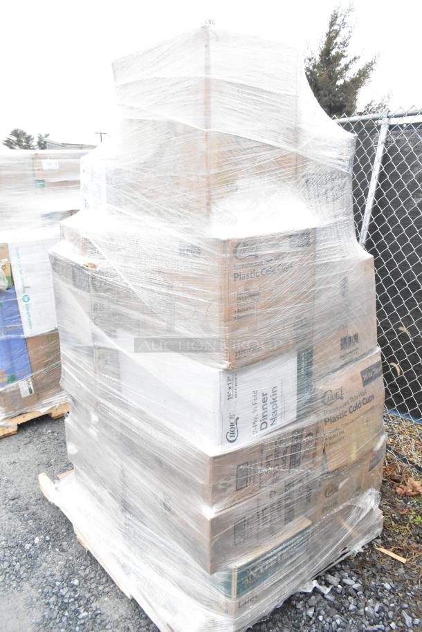 Plastic-wrapped pallet with boxed scratch and dent items. Brands visible, includes shopping bags, hot cups, and food bags.
