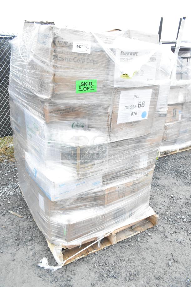 Plastic-wrapped pallet with boxed items including T-shirt bags, plastic tumblers, and paper towels. Labels indicate 38 pieces.