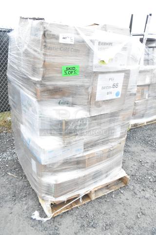 Plastic-wrapped pallet with boxed items including T-shirt bags, plastic tumblers, and paper towels. Labels indicate 38 pieces.