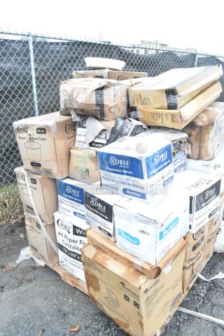 Boxes of scratch and dent items including Noble gloves, Choice paper cups, and more, stacked outdoors.