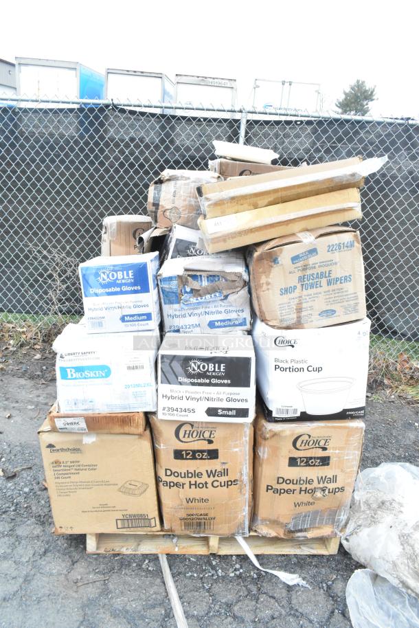 Boxes of new scratch and dent items, including Noble gloves, Choice cups, and shop towel wipers, stacked on a pallet.