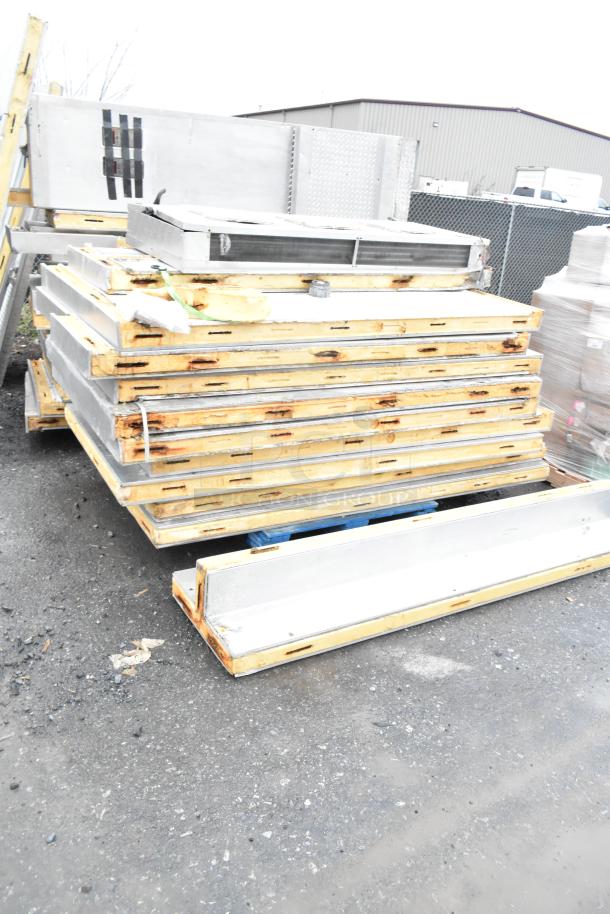 Stacks of walk-in box panels, slightly rusted, missing compressors, condensers, and evaporator fans.