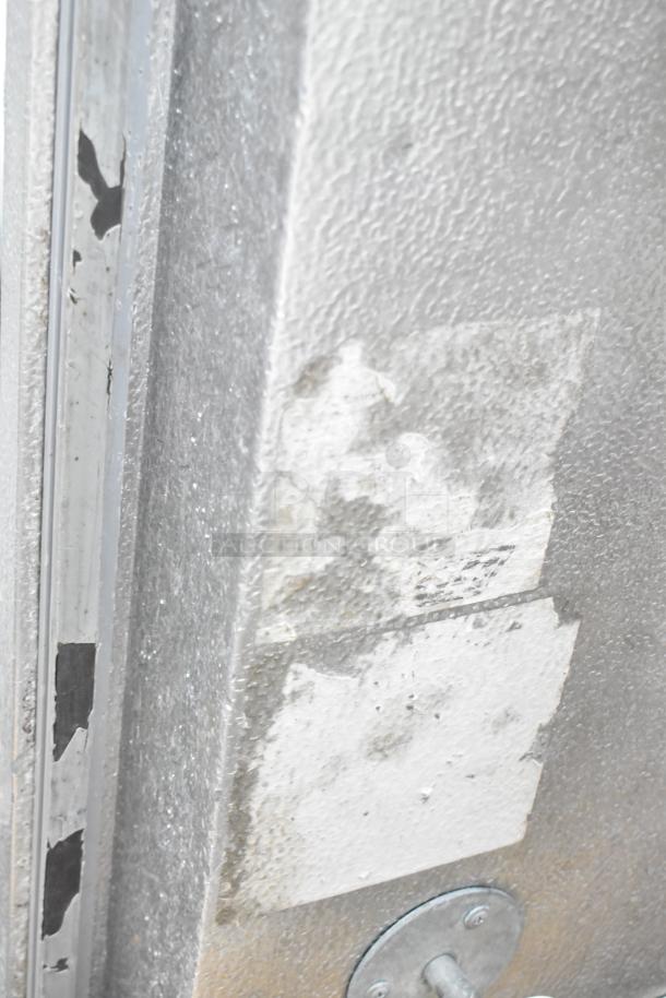 Close-up of a metal panel from Penn walk-in box combo; note partial wear and surface marks. No compressors included.