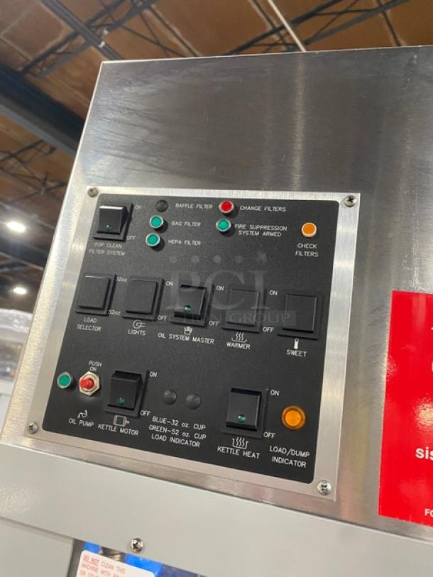 Gold Medal 2973-137 popcorn machine control panel, buttons labeled for filter, lights, warmer, and oil system functions.