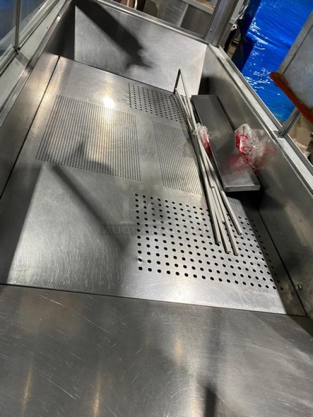 Stainless steel interior of Gold Medal Model 2973-137 popcorn popper, featuring perforated metal surfaces, in good condition.