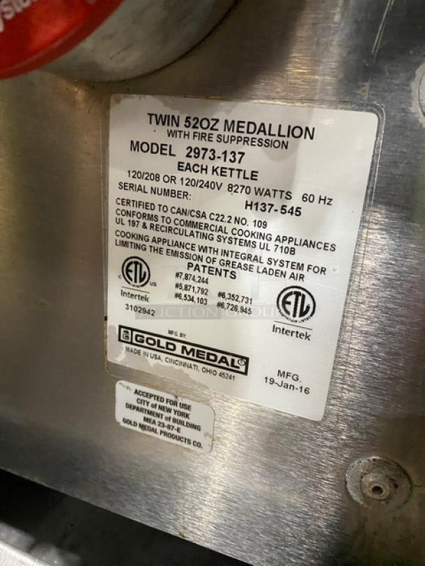 Gold Medal popcorn machine label, Model 2973-137, Twin 52 oz kettles, Serial H137-545, 120/208V or 120/240V, certified appliances.