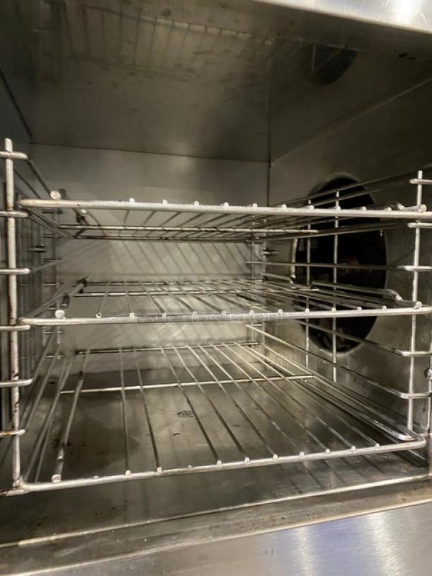 Groen CC10G commercial stainless steel convection/combo steamer oven interior with wired oven rack, natural gas powered.