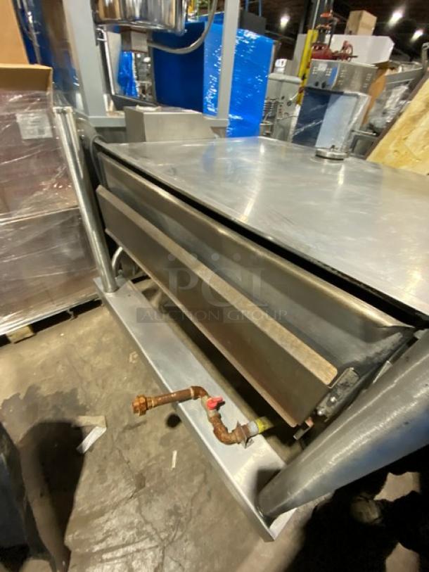 Cleveland Range commercial stainless steel gas-powered tilted braising pan, ultra tilt skillet, on sturdy legs, industrial use.