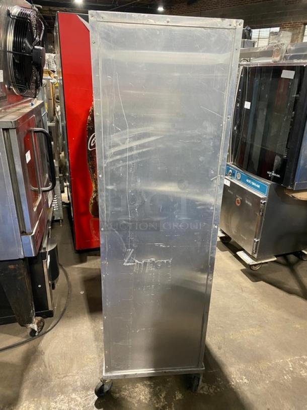 Commercial heavy-duty enclosed pan holding and transport rack on casters; metallic finish, shows signs of wear, ideal for kitchen use.