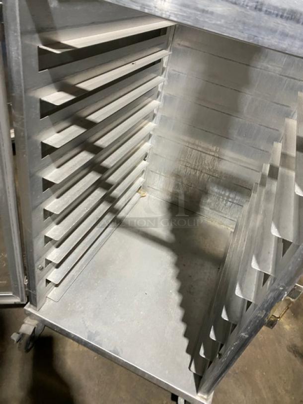 Commercial heavy-duty enclosed pan holding/transport rack on casters, metal, multiple shelves, used condition.
