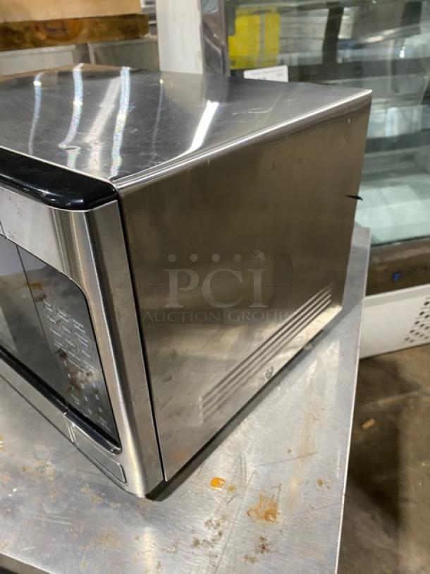 GE Appliances 2018 stainless steel countertop microwave, model JES1145SH1SS, in used condition.
