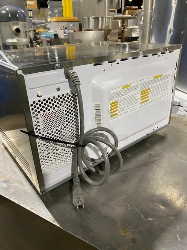 GE Appliances JES1145SH1SS stainless steel countertop microwave, 2018 model, electric-powered, visible serial number LL287868A.