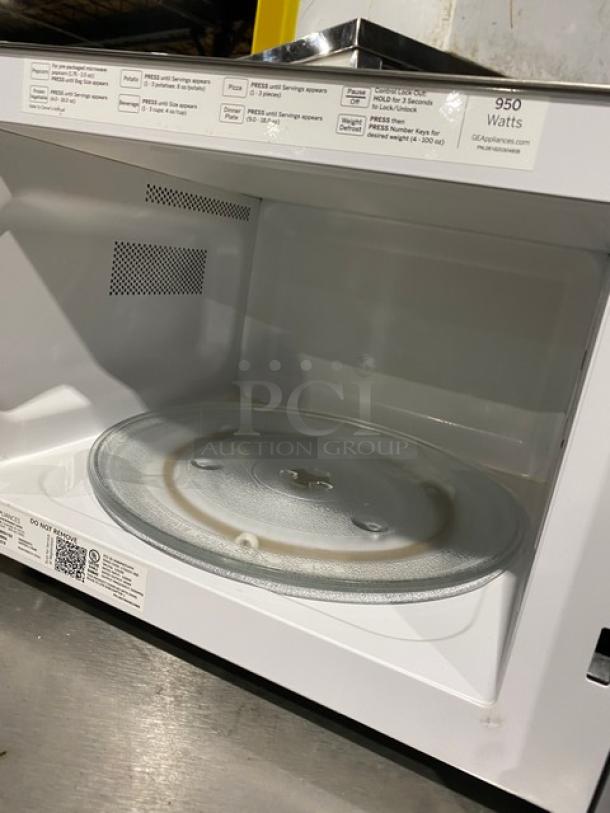 GE JES1145SH1SS stainless steel microwave oven, 950 watts, 2018 model, clean interior with glass turntable, serial LL287868A.