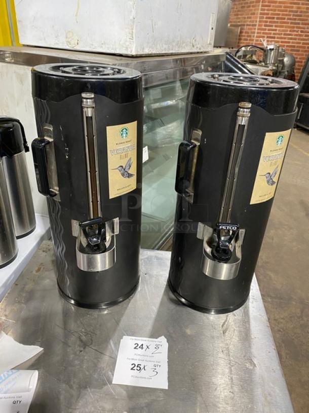 Fetco black insulated beverage dispenser, Starbucks style, features stainless spout and handles, used condition, includes labels.