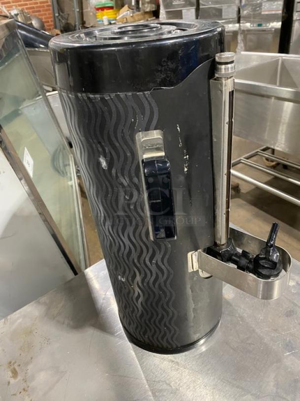 Fetco commercial black insulated beverage dispenser with spout. Used condition, Starbucks style. Wave design on exterior.