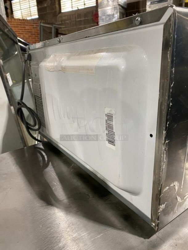 GE JES1651SJ02 stainless steel countertop microwave, electric-powered, 2009 model, SN: RS903160U. Used condition, visible wear.