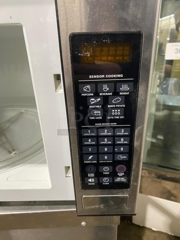 GE Appliances 2009 stainless steel countertop microwave, Model JES1651SJ02. Features sensor cooking, digital display.