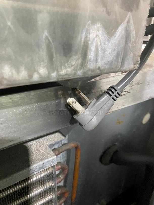 GE Appliances stainless steel countertop microwave model JES1651SJ02, 2009, commercial grade, electric plug detail.