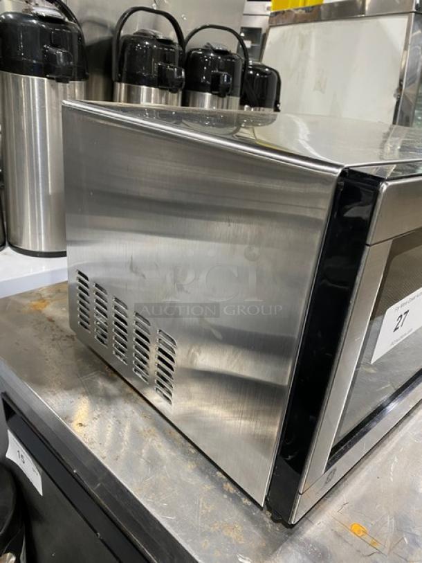 GE commercial stainless steel countertop microwave, model JES1142SJ06, 2010, electric powered, visible surface wear.