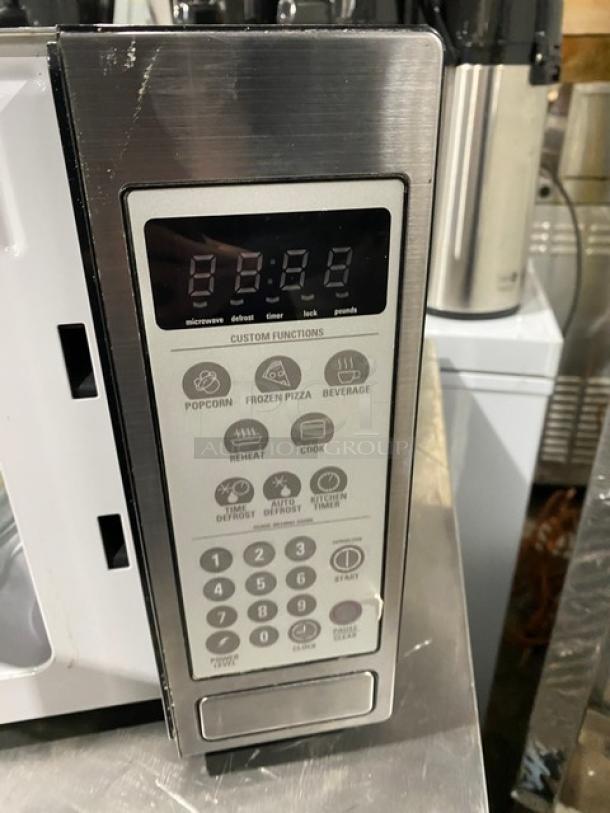 GE Appliances commercial stainless steel microwave, model JES1142SJ06, features custom functions and digital display.