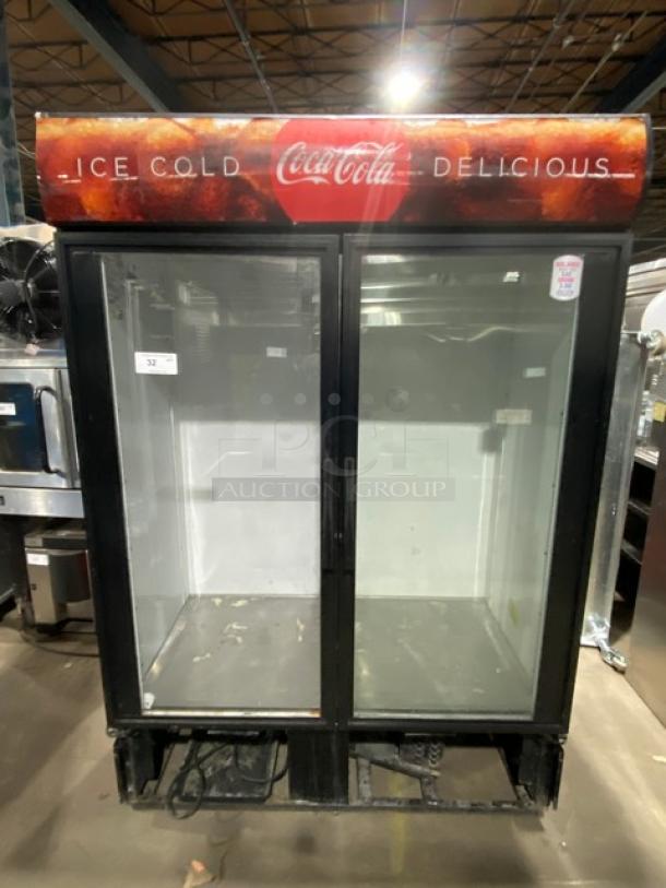 True GDM-49 commercial double glass door refrigerator, condition shows wear. Coca-Cola branding visible on top. Model and serial number noted.