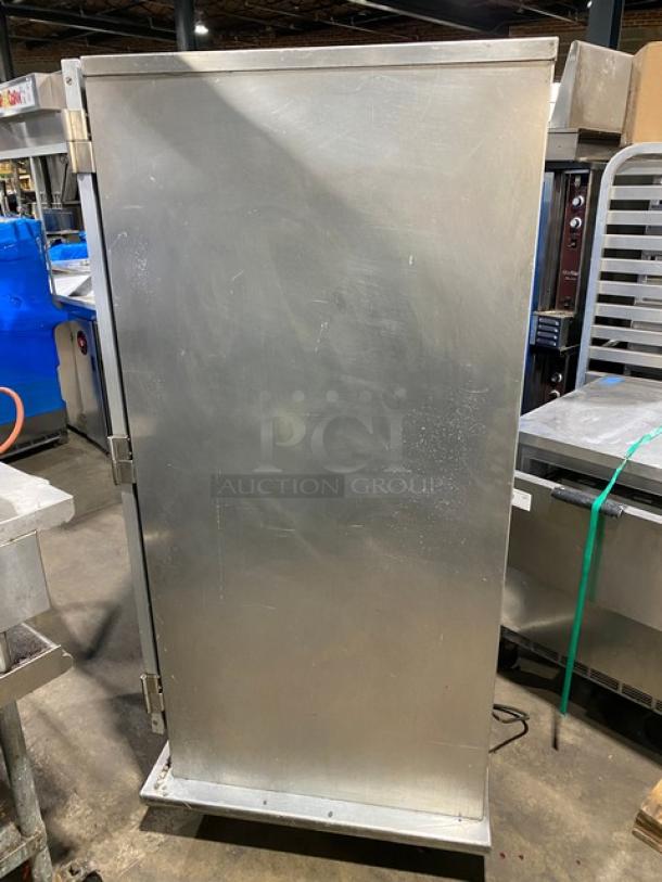 Commercial stainless steel insulated heating/proofing cabinet, electric powered, with pan holding racks on casters. Minor wear.