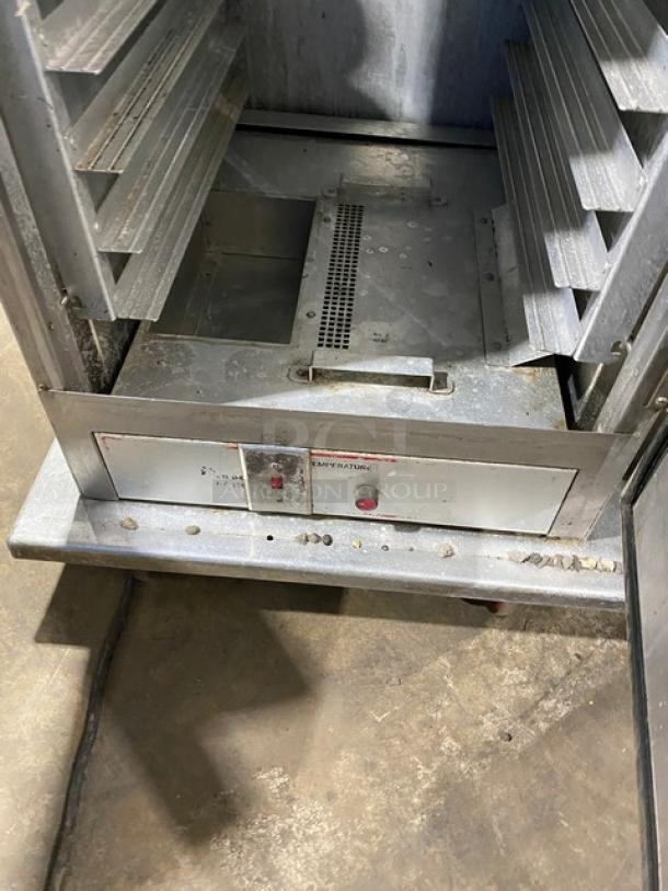 Commercial stainless steel insulated heating/proofing cabinet, electric powered, with built-in pan holding racks, on casters.