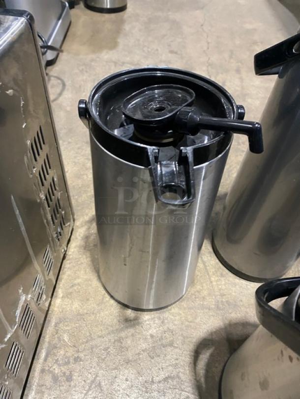 Commercial stainless steel insulated beverage dispenser, top spout, cylinder shape, used condition.