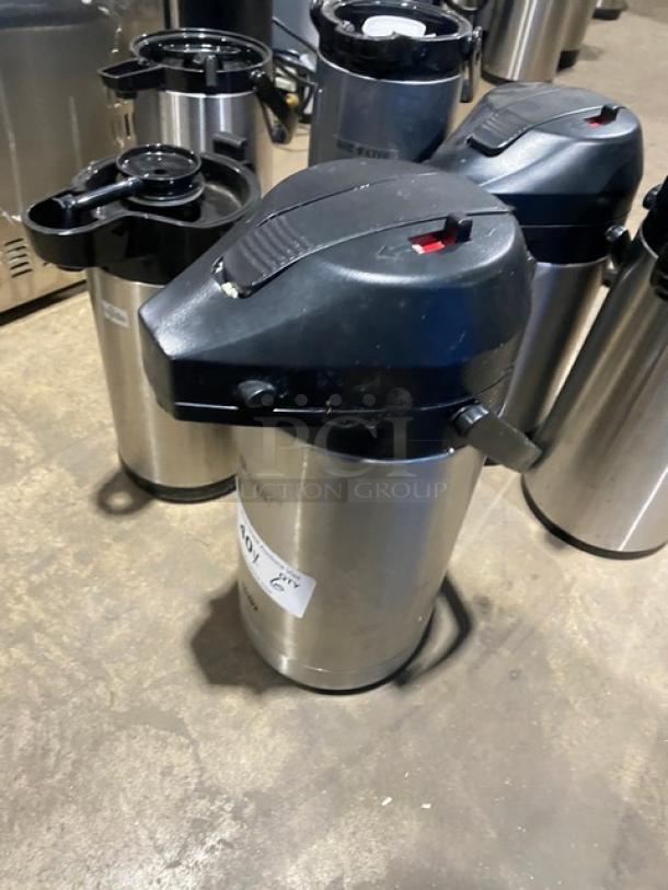 Commercial stainless steel insulated beverage dispenser in good condition. Features a black lid and pump mechanism, labeled as lot 407.