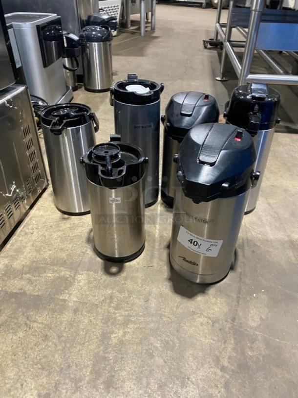 Stainless Steel Insulated Beverage Dispensers in good condition. Multiple units shown, some labeled "Hot Water." Suitable for commercial use.