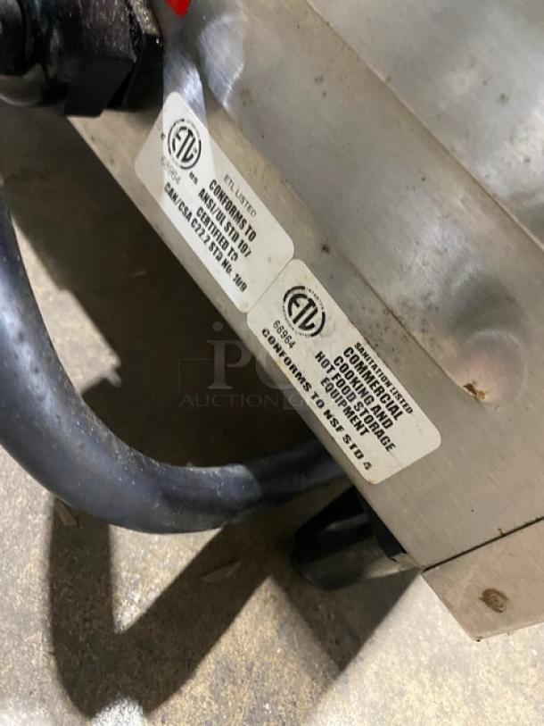 Lang PB12 commercial stainless steel panini griddle with grooved grates. ETL safety labels visible, on legs, pre-owned.