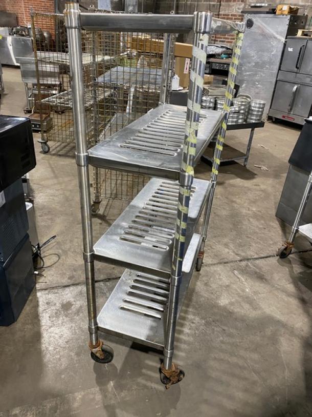 Commercial heavy-duty 4-tier mobile drying rack on casters, metal construction, slotted shelves, used condition.