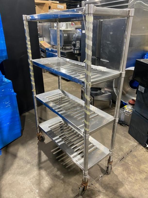 Commercial heavy-duty 4-tier mobile drying rack on casters. Made of stainless steel, showing shelving for utility use. Excellent condition.