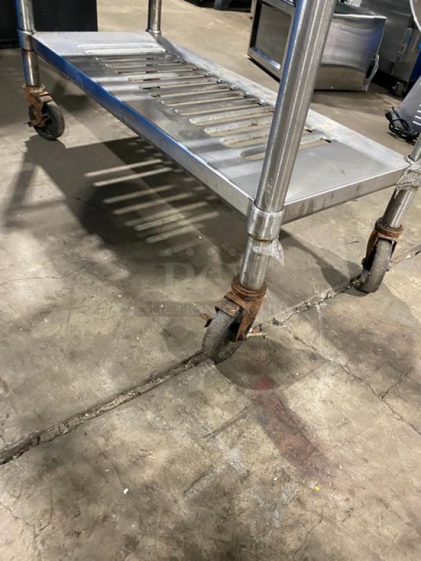 Commercial heavy-duty 4-tier mobile drying utility rack on casters. Metal construction, shows wear. Ideal for industrial use.