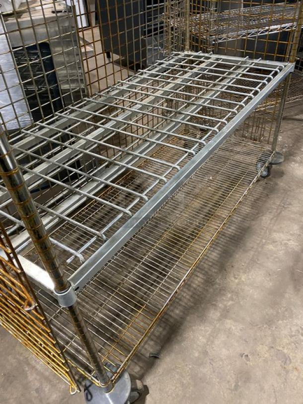 Commercial 4-tier mobile enclosed wired-rack utility storage cart on casters, metal construction, lightly used.